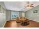 Bright living room featuring a large window, comfortable sofa, wood floors, and soft neutral wall colors at 600 River Bend Sw Cir, Smyrna, GA 30082