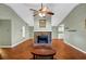 Living room with a vaulted ceiling, stone fireplace, and wood floors with a view into the dining area at 600 River Bend Sw Cir, Smyrna, GA 30082