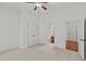Spacious bedroom featuring neutral carpet, ceiling fan, and an attached bathroom at 1345 Hilltop Overlook Dr, Marietta, GA 30062
