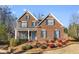Attractive two-story brick home with a welcoming front porch and beautifully landscaped front yard at 1345 Hilltop Overlook Dr, Marietta, GA 30062