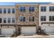 Townhome with stone and painted brick facade, garage, and well-maintained landscaping at 160 Chiswick Cir # 2, Alpharetta, GA 30009