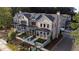View of townhomes featuring manicured lawns, covered entryways and beautiful landscaping at 160 Chiswick Cir # 2, Alpharetta, GA 30009