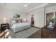 This main bedroom features a ceiling fan, area rug, and an ensuite bathroom with an entry door at 160 Chiswick Cir # 2, Alpharetta, GA 30009