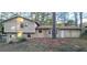 Rear view of the home features classic siding, trimmed trees, and outdoor access at 3226 Bruckner Blvd, Snellville, GA 30078