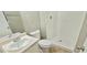 Bathroom with white sink, toilet, and shower stall with white tiles at 3226 Bruckner Blvd, Snellville, GA 30078