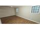 Bedroom with laminate flooring, natural lighting, and a neutral color scheme at 3226 Bruckner Blvd, Snellville, GA 30078