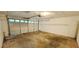 A spacious garage with concrete floors and a white garage door at 3226 Bruckner Blvd, Snellville, GA 30078