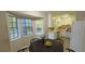 Bright kitchen with white appliances and an eat-in area surrounded by large windows at 3226 Bruckner Blvd, Snellville, GA 30078