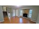 Inviting living room with hardwood floors, stone fireplace, and natural light from the windows at 3226 Bruckner Blvd, Snellville, GA 30078