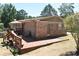 Charming brick home featuring an expansive wooden deck for outdoor relaxation and entertainment at 3400 Scott Dr, Austell, GA 30106