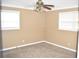 Bedroom with neutral walls, carpet floors, crown molding, and natural light from two windows at 3400 Scott Dr, Austell, GA 30106