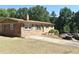 Charming brick ranch with green shutters, mature trees, and a long driveway at 3400 Scott Dr, Austell, GA 30106