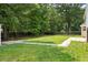 Large backyard with green grass and a wooden fence at 5399 Emily Cir, Ellenwood, GA 30294