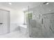Beautiful bathroom with tub and large glass shower with marble style tile surround at 5399 Emily Cir, Ellenwood, GA 30294