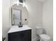 Stylish half-bathroom with modern vanity, gold framed mirror and sleek fixtures at 5399 Emily Cir, Ellenwood, GA 30294