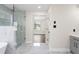Luxury bathroom featuring tiled floors, tub and seamless glass shower at 5399 Emily Cir, Ellenwood, GA 30294
