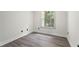 This bedroom features hardwood floors, neutral walls and a window at 5399 Emily Cir, Ellenwood, GA 30294