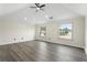 Spacious bedroom with ample natural light, featuring a modern ceiling fan and neutral walls at 5399 Emily Cir, Ellenwood, GA 30294