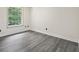 Bedroom with large window and light grey laminate floors at 5399 Emily Cir, Ellenwood, GA 30294