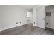 Bedroom with grey laminate floors and closet with sliding doors at 5399 Emily Cir, Ellenwood, GA 30294