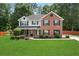 Well-maintained two-story home with a manicured lawn and mature landscaping at 5399 Emily Cir, Ellenwood, GA 30294