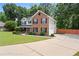 Inviting two-story home with brick and siding, featuring a long driveway and nicely landscaped front yard at 5399 Emily Cir, Ellenwood, GA 30294