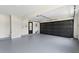 Spacious garage with a black door at 5399 Emily Cir, Ellenwood, GA 30294