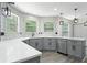 Bright kitchen featuring gray cabinets, quartz countertops, stainless steel appliances, and modern lighting at 5399 Emily Cir, Ellenwood, GA 30294