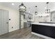 Newly renovated kitchen with grey cabinets, marble backsplash, and modern black and gold light fixtures at 5399 Emily Cir, Ellenwood, GA 30294