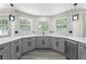 Updated kitchen featuring gray cabinets, quartz countertops, stainless steel appliances, and a modern faucet at 5399 Emily Cir, Ellenwood, GA 30294