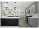 Modern kitchen featuring gray cabinets, quartz countertops, sleek appliances, and stylish pendant lighting at 5399 Emily Cir, Ellenwood, GA 30294