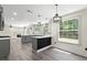 Open concept kitchen features grey cabinets, marble countertops and backsplash, and modern lighting at 5399 Emily Cir, Ellenwood, GA 30294