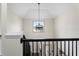 Upper landing with modern lighting and a view of the entryway creates an inviting space at 5399 Emily Cir, Ellenwood, GA 30294