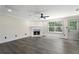 Inviting living room featuring a cozy fireplace, neutral walls, and large windows for ample natural light at 5399 Emily Cir, Ellenwood, GA 30294