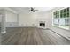 Bright living room with modern fireplace, large windows, and sleek floors create a cozy space at 5399 Emily Cir, Ellenwood, GA 30294