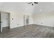 Spacious main bedroom featuring new light grey flooring and a modern ceiling fan at 5399 Emily Cir, Ellenwood, GA 30294