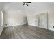 Bright, large main bedroom with new light grey floors and a ceiling fan at 5399 Emily Cir, Ellenwood, GA 30294