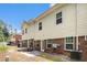 The rear exterior view features a patio, lawn, air conditioning units, brick, and siding at 876 Ivydale Ln # 63, Lawrenceville, GA 30045