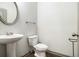Bathroom with a pedestal sink, a toilet, wood floors, and modern fixtures at 876 Ivydale Ln # 63, Lawrenceville, GA 30045