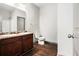 Bathroom features double sink vanity, wood floors, neutral walls, and modern fixtures at 876 Ivydale Ln # 63, Lawrenceville, GA 30045