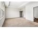 Large bedroom with plush carpeting, tray ceiling, natural light, and an ensuite bathroom at 876 Ivydale Ln # 63, Lawrenceville, GA 30045