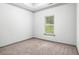 Bedroom features a plush carpet, a single window, and neutral walls at 876 Ivydale Ln # 63, Lawrenceville, GA 30045
