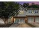 Charming townhome features a brick-accented garage and beautiful gray siding at 876 Ivydale Ln # 63, Lawrenceville, GA 30045