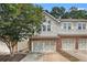 Charming townhome features a brick-accented garage and beautiful gray siding at 876 Ivydale Ln # 63, Lawrenceville, GA 30045