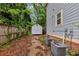 Backyard features a shed, AC units, wooden fence, and mature trees at 1103 Coleman Sw St, Atlanta, GA 30310
