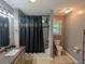 Well-lit bathroom featuring a shower-tub combo, granite vanity, and neutral color scheme at 1103 Coleman Sw St, Atlanta, GA 30310