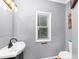 A full bathroom with a modern sink, a window for natural light, and gray walls at 1103 Coleman Sw St, Atlanta, GA 30310