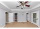 Open bedroom featuring three door options, neutral tones, and a ceiling fan at 1103 Coleman Sw St, Atlanta, GA 30310