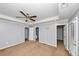 Large bedroom featuring three door options, neutral tones, and a ceiling fan at 1103 Coleman Sw St, Atlanta, GA 30310