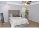 Spacious bedroom with neutral tones, tray ceiling, fan, and a plush, tufted headboard at 1103 Coleman Sw St, Atlanta, GA 30310